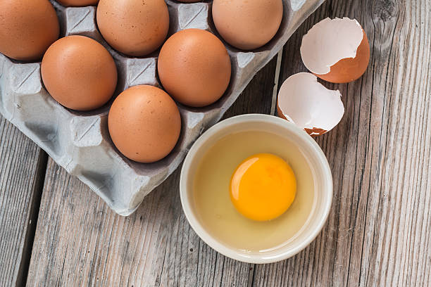 istock Eggs and Egg yolk in paper tray on wood 473096674
