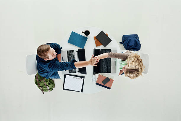 istock Above view of two students giving high five 473099600
