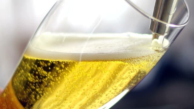Pouring beer into a glass close-up