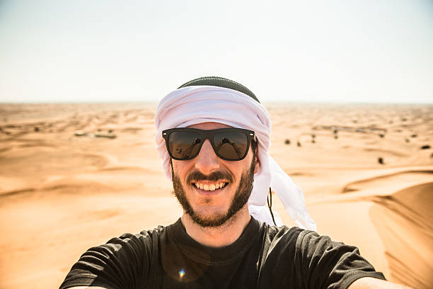 istock tourist man doing a selfie on the desert 473118006