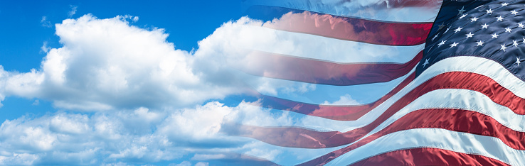 American flag on the sky, closeup pride flag, red and blue USA flag, democracy and freedom symbol, independence and patriotism united states, 4th of July, fabric banner close-up.