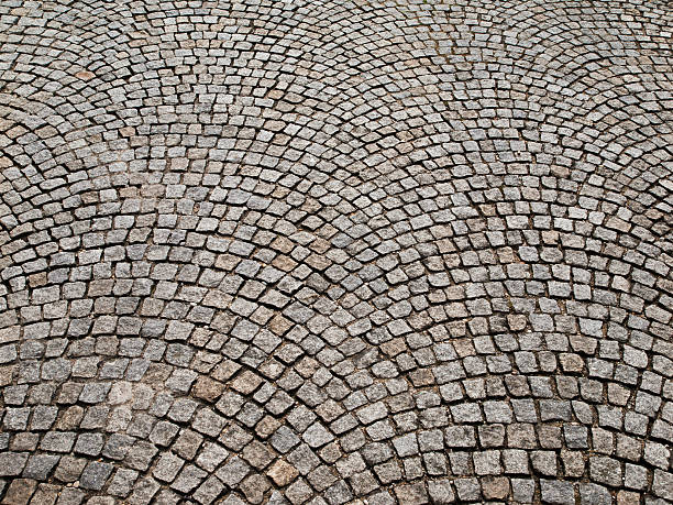 istock Cobbled pavement made of granite cubes 473118296