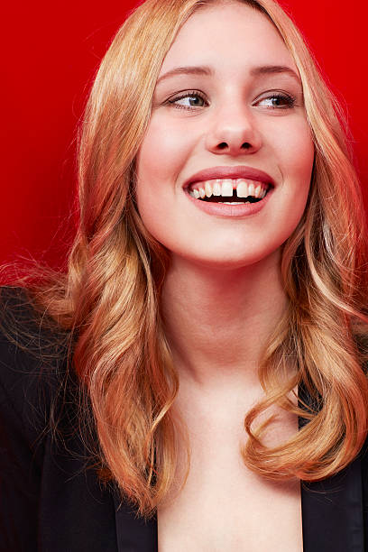 istock Smiling woman against red 473123876