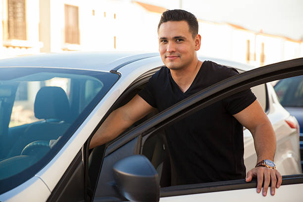 istock Man standing next to his car 473126358