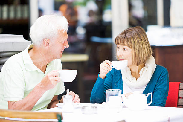 istock Senior couple sitting and talking in a Berlin cafe 473127312