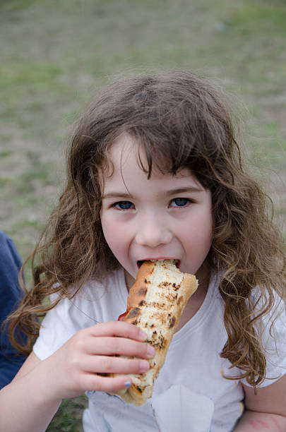Eating grilled hot dog