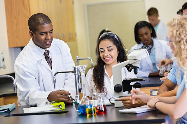 istock African American teacher teaching students in high school science classroom 473129888