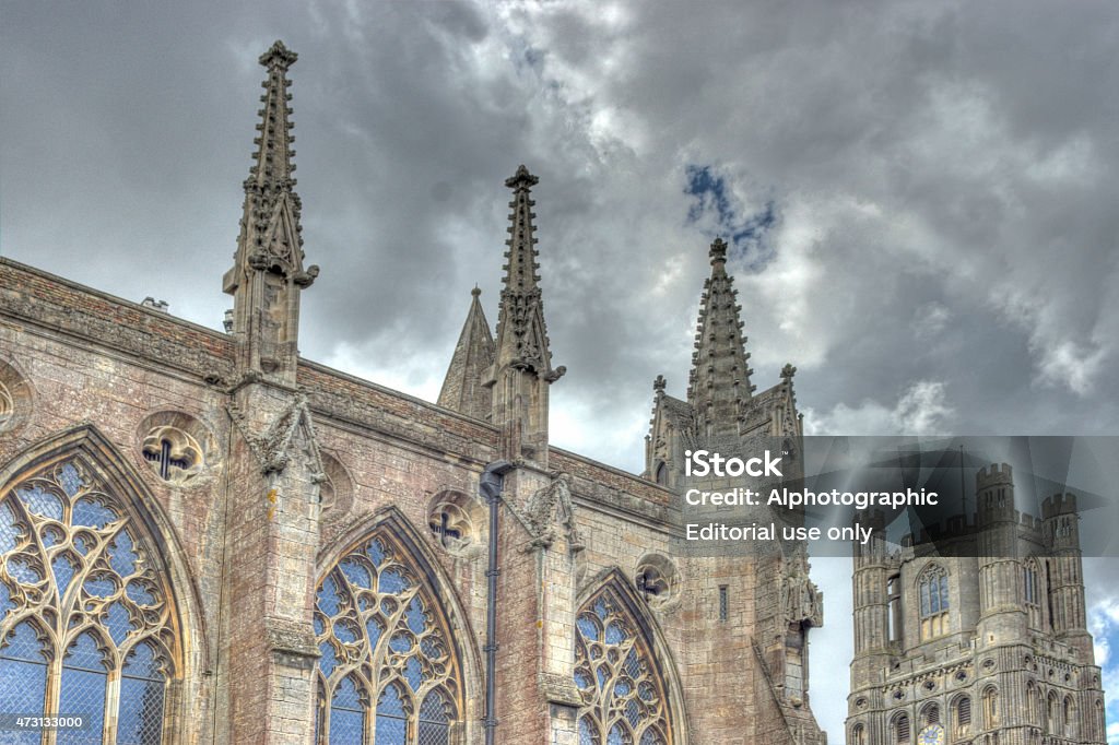 Ely Cathedral exterior Ely, United Kingdom - August 18, 2014: Ely Cathedral in Cambridgeshire taken from the open grass area surrounding it. This is a combination of 3 bracketed exposure 3 stops apart combined in HDR software to bring out detail in the shadows and the sky. 2015 Stock Photo