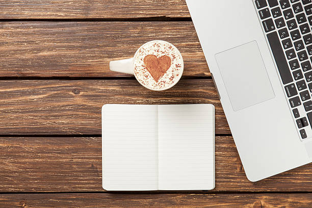 istock cappuccino and notebook near laptop 473139250