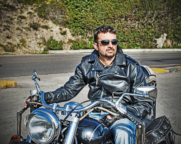 istock biker and his motorcycle in retro tone 473139412