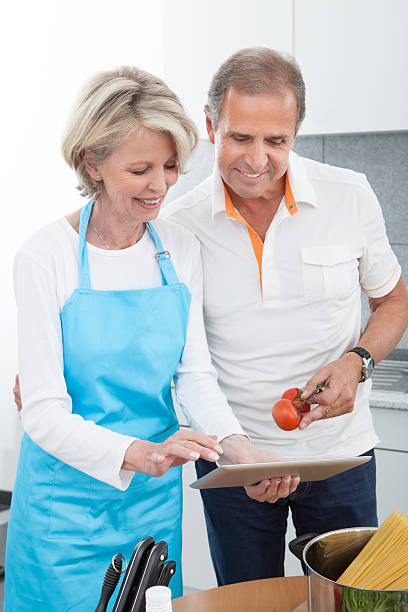istock Mature Couple Cutting Vegetables 473139510