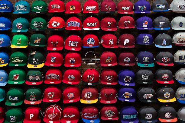 New York, NY, USA - November 9, 2014: Team sport caps on the wall in one of the store on the Brodway St. Manhattan.