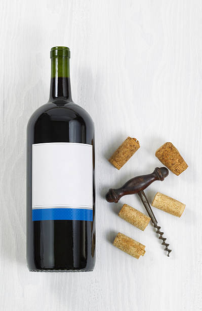 istock Unopened large bottle of red wine with an antique corkscrew 473142396