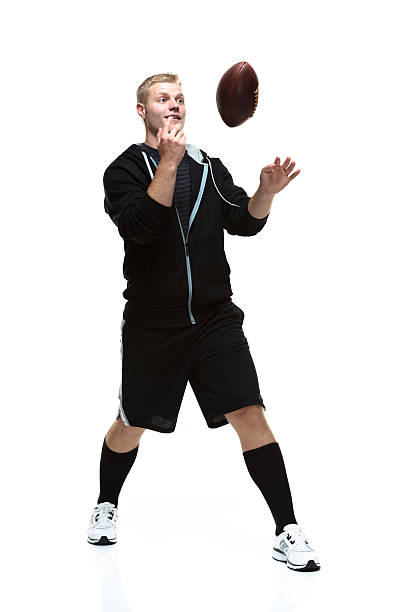 istock Student being playful with football 473142550