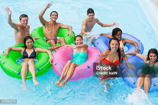 Teenage Friends Floating On Innertubes Stock Photo - Download Image Now - African Ethnicity, Inflatable Swim Ring, Looking Up