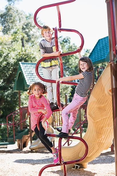 istock Three children climbing on playground equipment 473142798