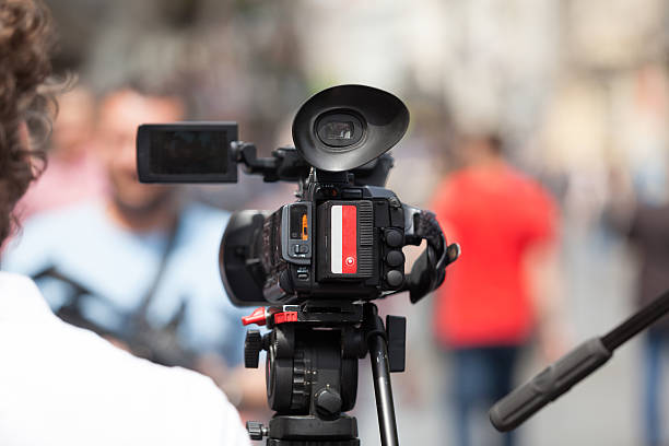 istock Filming an event with a video camera 473146298