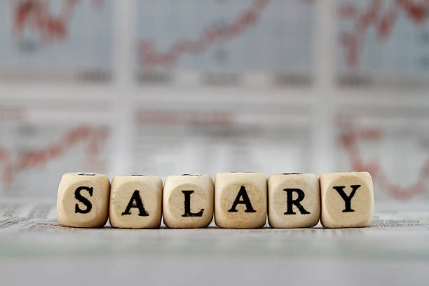 istock Salary word built with letter cubes on newspaper background 473147146