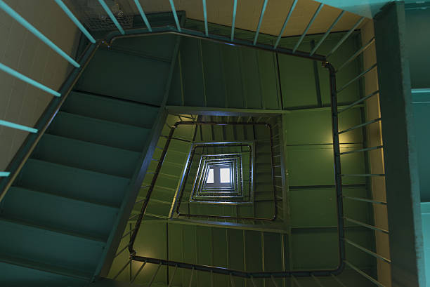 istock Grungy Spiral Staircase Bottom Looking Up 473147392