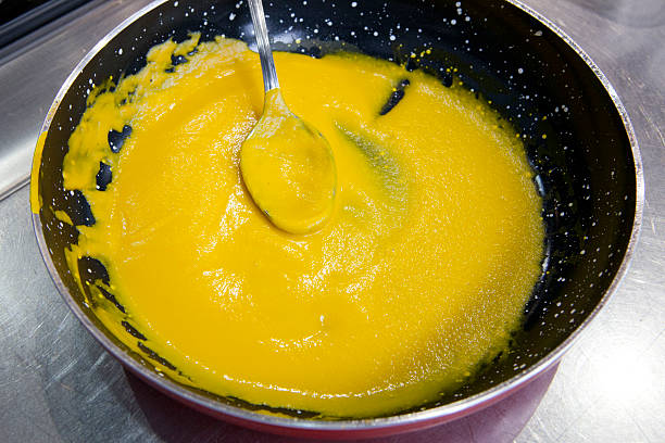 istock carrot; thick soup; black; yellow; spoon; pan; cooking; high cus 473148188