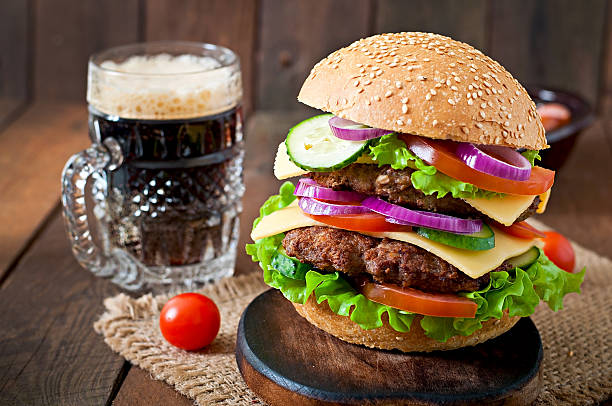 istock Big juicy hamburger with vegetables and beef 473148338