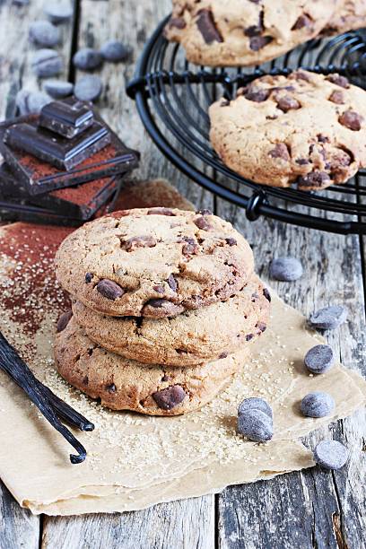 istock Double chocolate cookies with chocolate chips on a rustic wooden table. 473150258