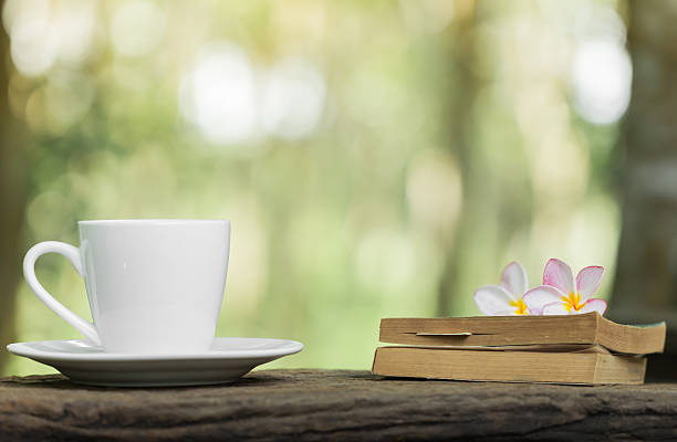 istock coffee cup book and pink  flower on wooden  table 473150308
