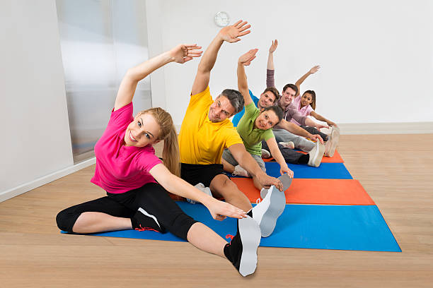 Group Of Diverse Multiethnic People Stretching Legs At Gym
