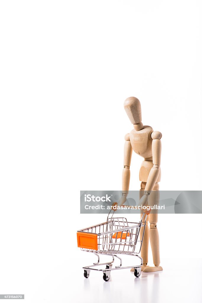 Orange metal shopping cart. Orange metal shopping cart with wooden manikin. 2015 Stock Photo