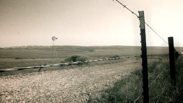 Vintage Film Grain Barbed Wire Windmill Farm