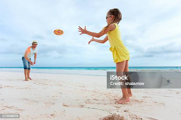 Father And Daughter Playing With Flying Disk Stock Photo - Download Image Now - 2015, Activity, Adult