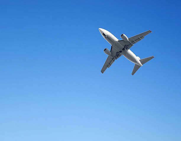 istock Airplane flying in the blue sky 473158912
