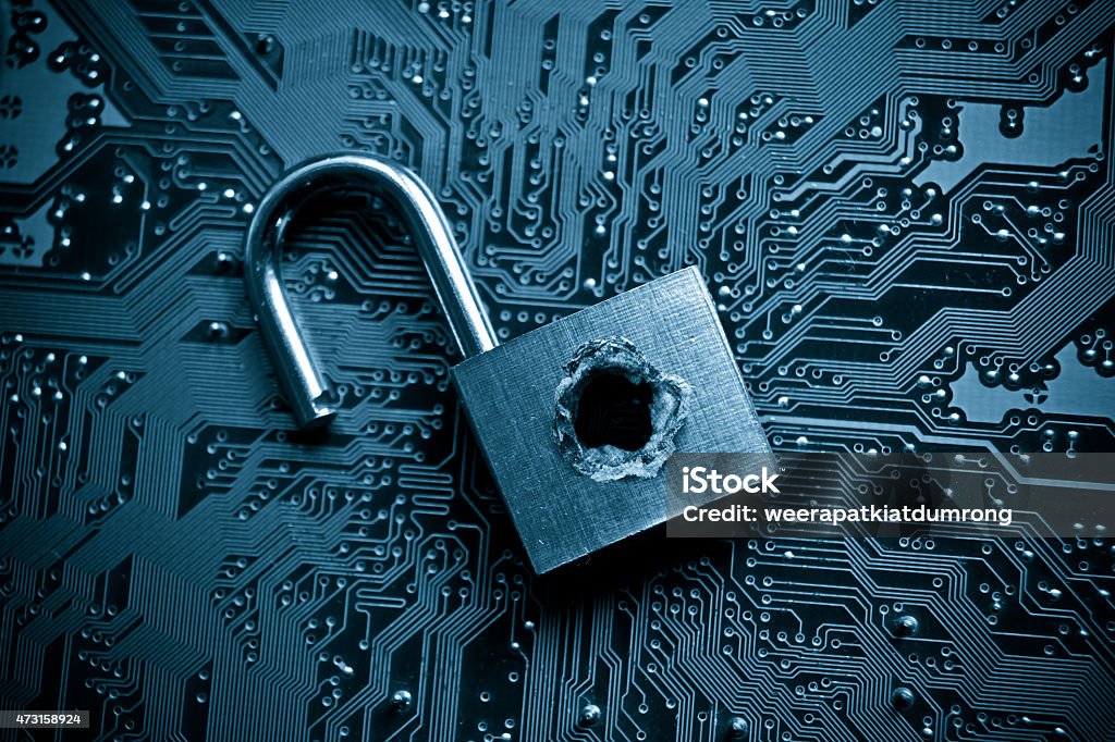 Padlock to represent computer security breach security lock with a hole on computer circuit board - computer security concept Internet Stock Photo