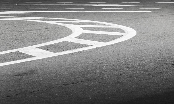 istock White bent lines over dark asphalt 473159102
