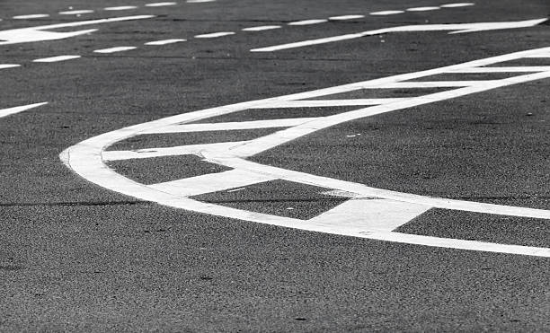 istock White lines over dark gray asphalt, road marking 473159112