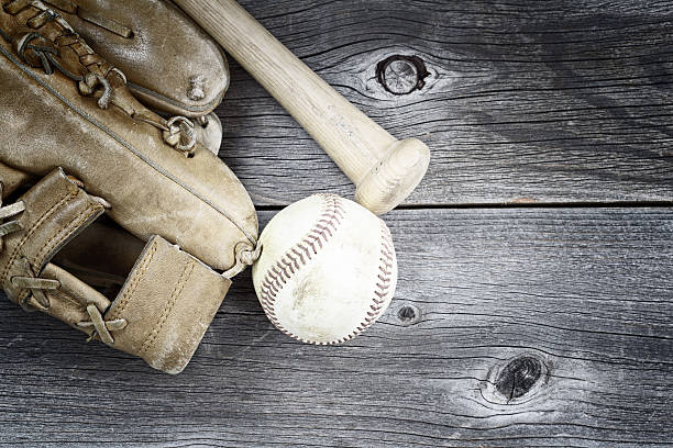 istock Used Baseball equipment on rustic wood 473159522