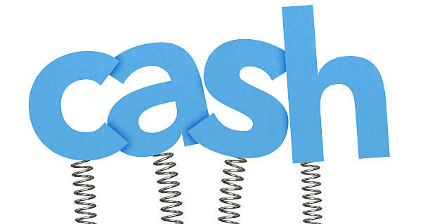 The word Cash is spelt out in blue lowercase paper letters. The letters are each attached to a metal spring at the bottom of the font. Each letter overlaps and casts a small shadow. The background is plain white.
