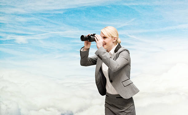 istock Smiling businesswoman searching with binoculars 473163556