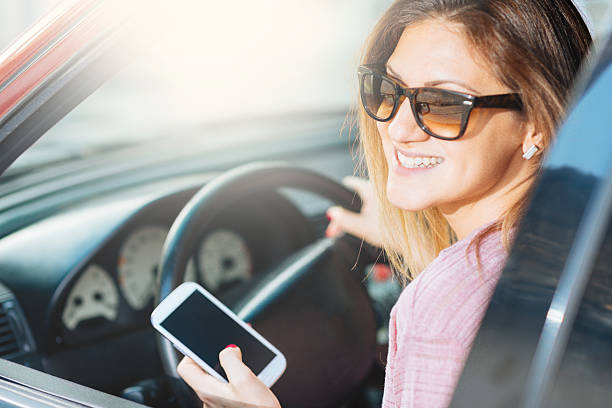 istock Smiling attractive woman texting message on smartphone while driving 473163738