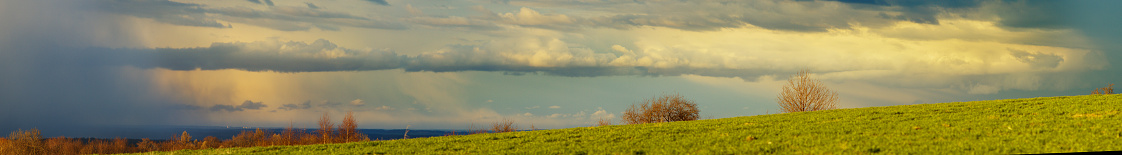 Panarama of a horizontal clouds chain on the colorful sunset