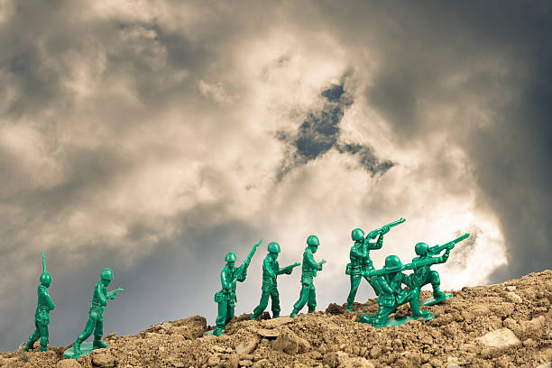 Toy Soldiers War Toy soldiers march along the horizon in war image toy soldier stock pictures, royalty-free photos & images