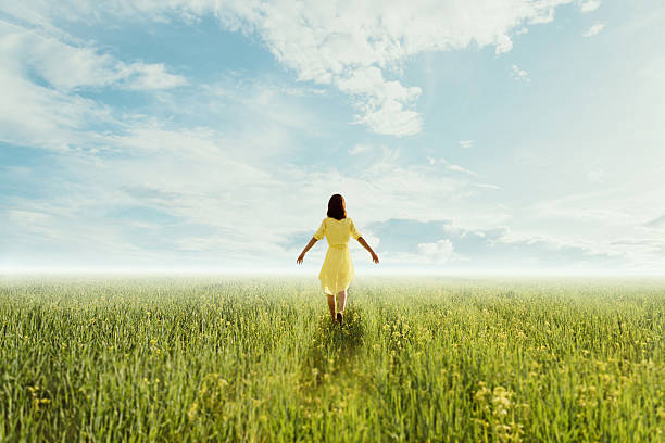 istock Young woman walking on summer meadow 473165006