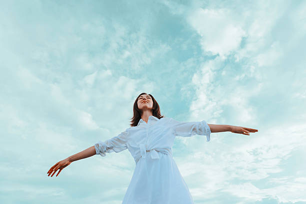 istock Young woman with raised arms enjoying a nice day 473166268