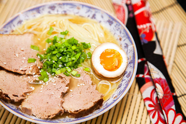 Salt ramen garnished with meat, egg and spring onion