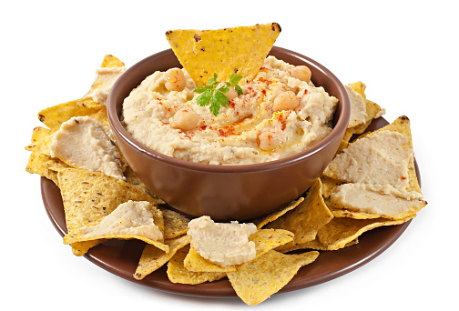 Healthy homemade hummus with olive oil and pita chips isolated on white background