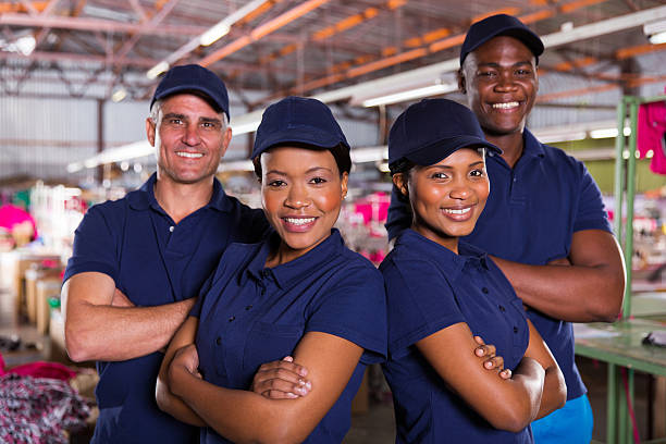 istock textile factory co-workers with arms crossed 473168928