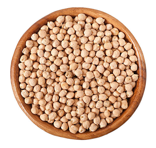istock Uncooked chickpeas in wooden bowl on white background 473169580