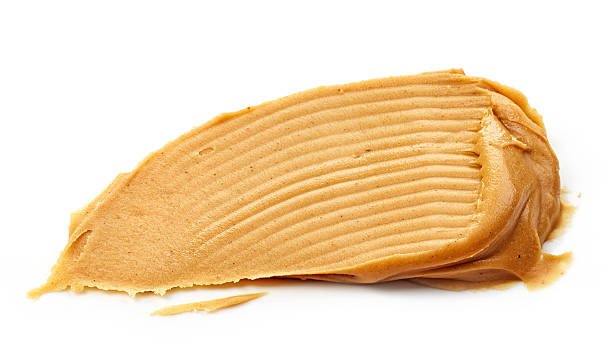 peanut butter spread peanut butter spread isolated on white background spreading stock pictures, royalty-free photos & images