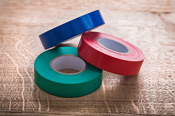 istock three rolls of insulating tape on wooden board construction conc 473173400