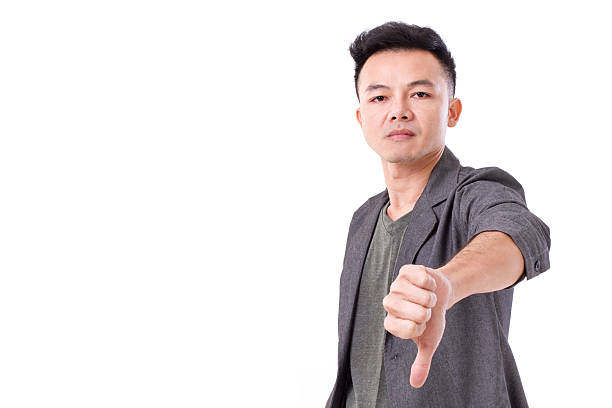 istock man giving thumb down,  looking at you or camera 473174460